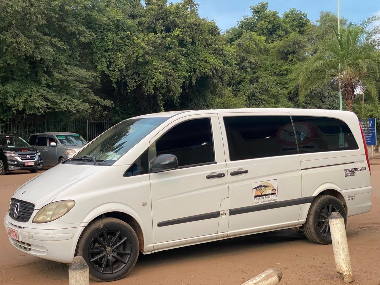 Excellence Trails safari van parked under trees in Victoria Falls