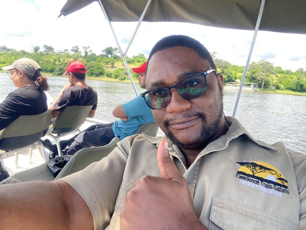 Excellence Trails guide on a Chobe River boat cruise with guests behind him
